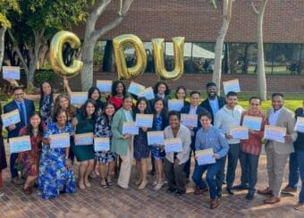 Group photo of the UCLA/CDU medical students holding signs of where they will complete their residency.