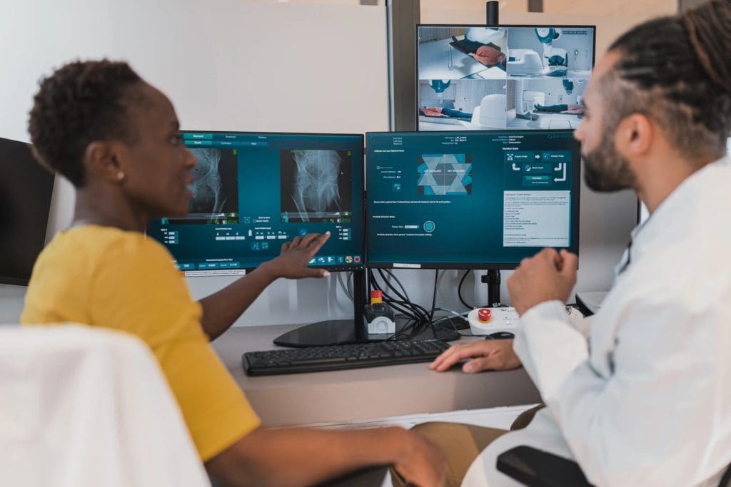 Two students review radiology scans at a computer
