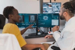 Two students review radiology scans at a computer