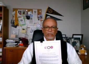 CDU President Dr. David Carlisle holds his signed Memorandum of Understanding the special Three-Year Bachelor Degree program.
