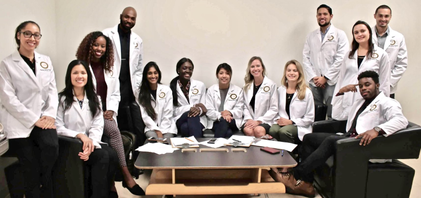 Group photo of CDU Physician Assistant students wearing their white coats.