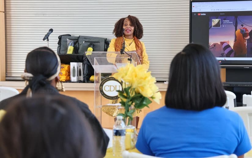 Adrienne Milbourne-Thompson, Academic Support Specialist, speaks at event