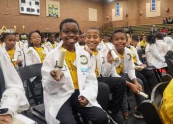 Elementary school students wear their white coats during the Junior White Coat Ceremony.