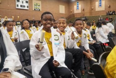 Elementary school students wear their white coats during the Junior White Coat Ceremony.