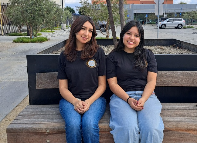 Two young ladies sitting at a bench | Pathways to Health Careers Academy