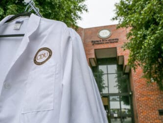 White coat in front of Cobb building