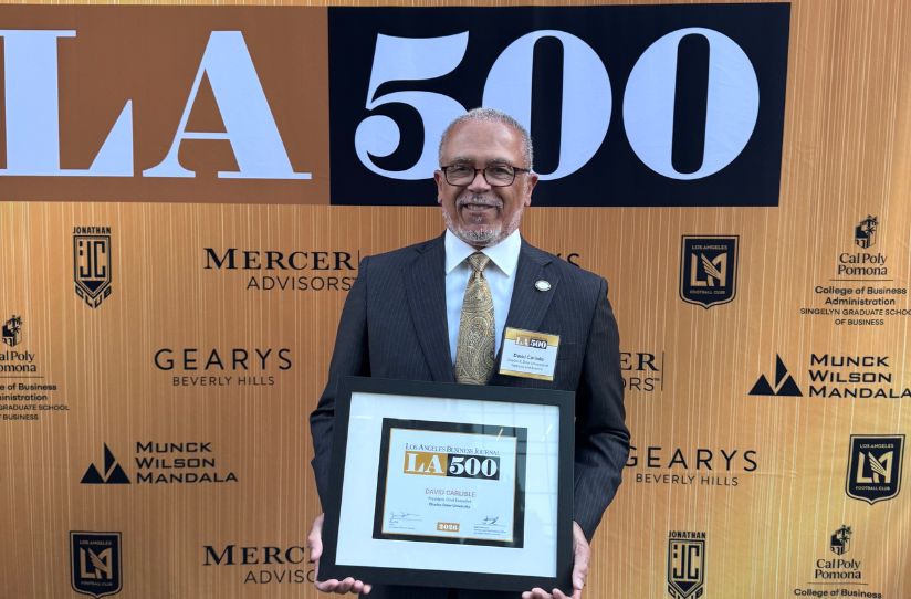 Dr. Carlisle holding LA500 plaque