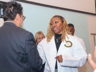 Zsaniece Young in white coat