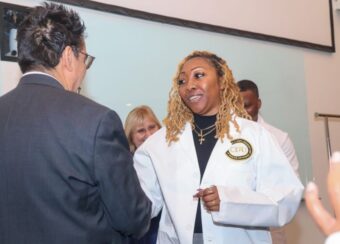 Zsaniece Young in white coat