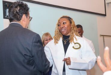 Zsaniece Young in white coat