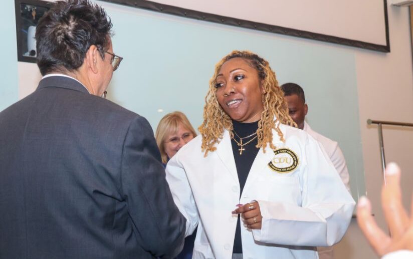 Zsaniece Young in white coat