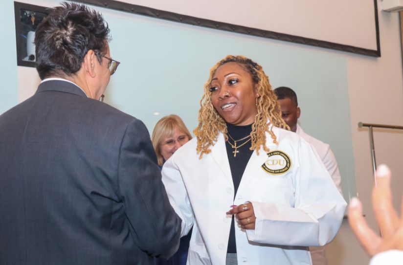 Zsaniece Young in white coat